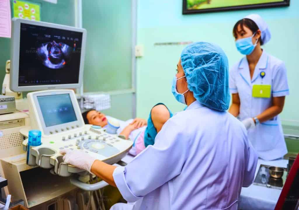 Hình ảnh người bác sĩ đang siêu âm bụng cho bệnh nhân