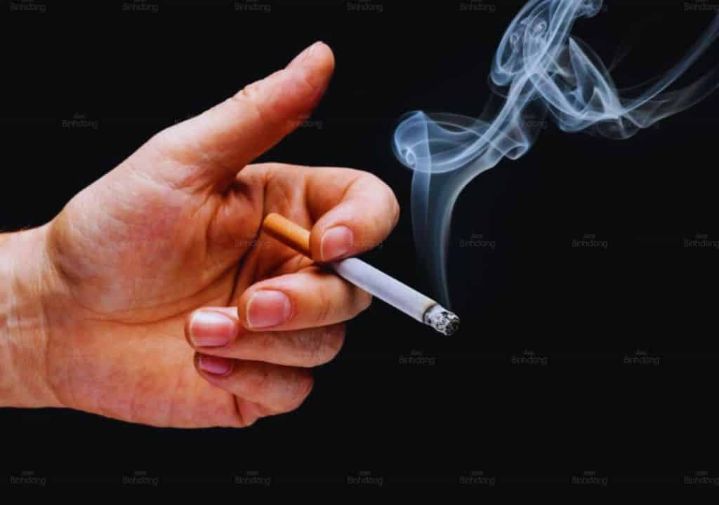 Hình ảnh một người đàn ông đang cầm điếu thuốc và chuẩn bị hút