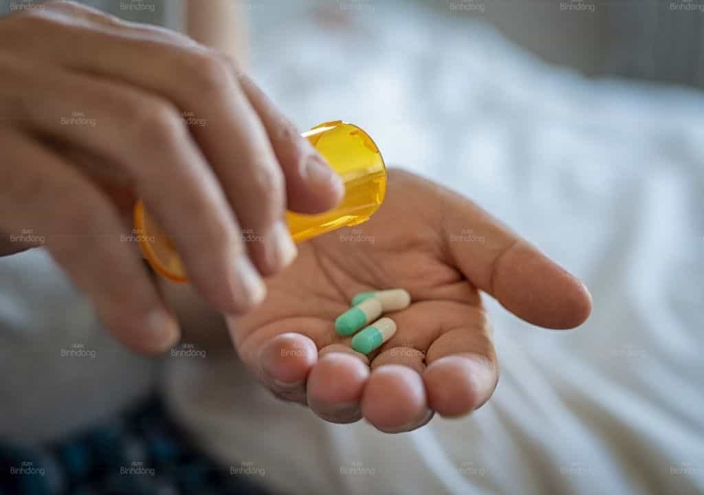 Hình ảnh người phụ nữ đang uống thuốc phòng kinh nguyệt 1 tháng ra 3 lần