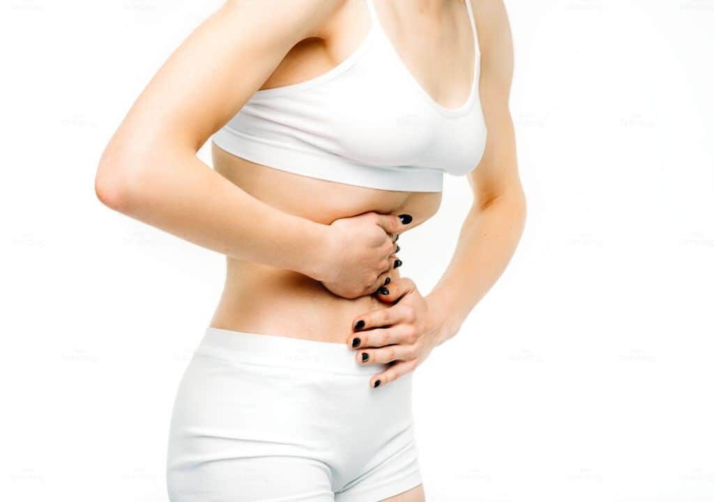 Hình ảnh người phụ nữ đang bị trễ kinh kèm đau bụng dưới