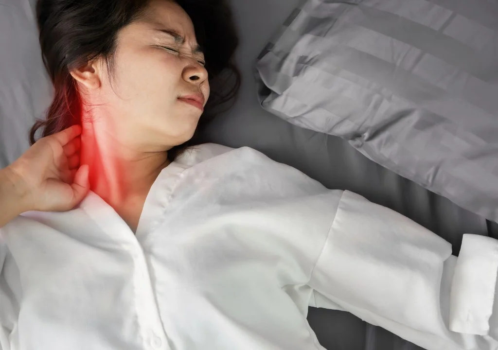 Người phụ nữ bị đau cổ vai gáy do ngủ sai tư thế sau khi thức dậy
