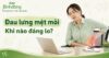 Người phụ nữ ngồi làm việc, một tay giữ thắt lưng với vẻ mệt mỏi. Tiêu đề “Đau lưng mệt mỏi: Khi nào đáng lo?