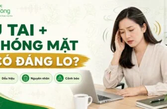 Người phụ nữ ngồi làm việc, một tay chạm tai với biểu hiện khó chịu. Thumbnail ghi “Ù tai + chóng mặt: Có đáng lo?”; Dấu hiệu, Nguyên nhân, Cảnh báo.